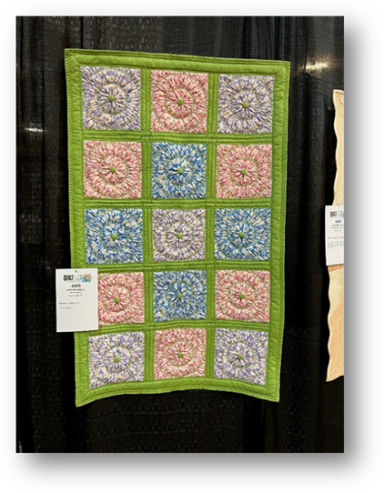 A colorful quilt on a black background

Description automatically generated